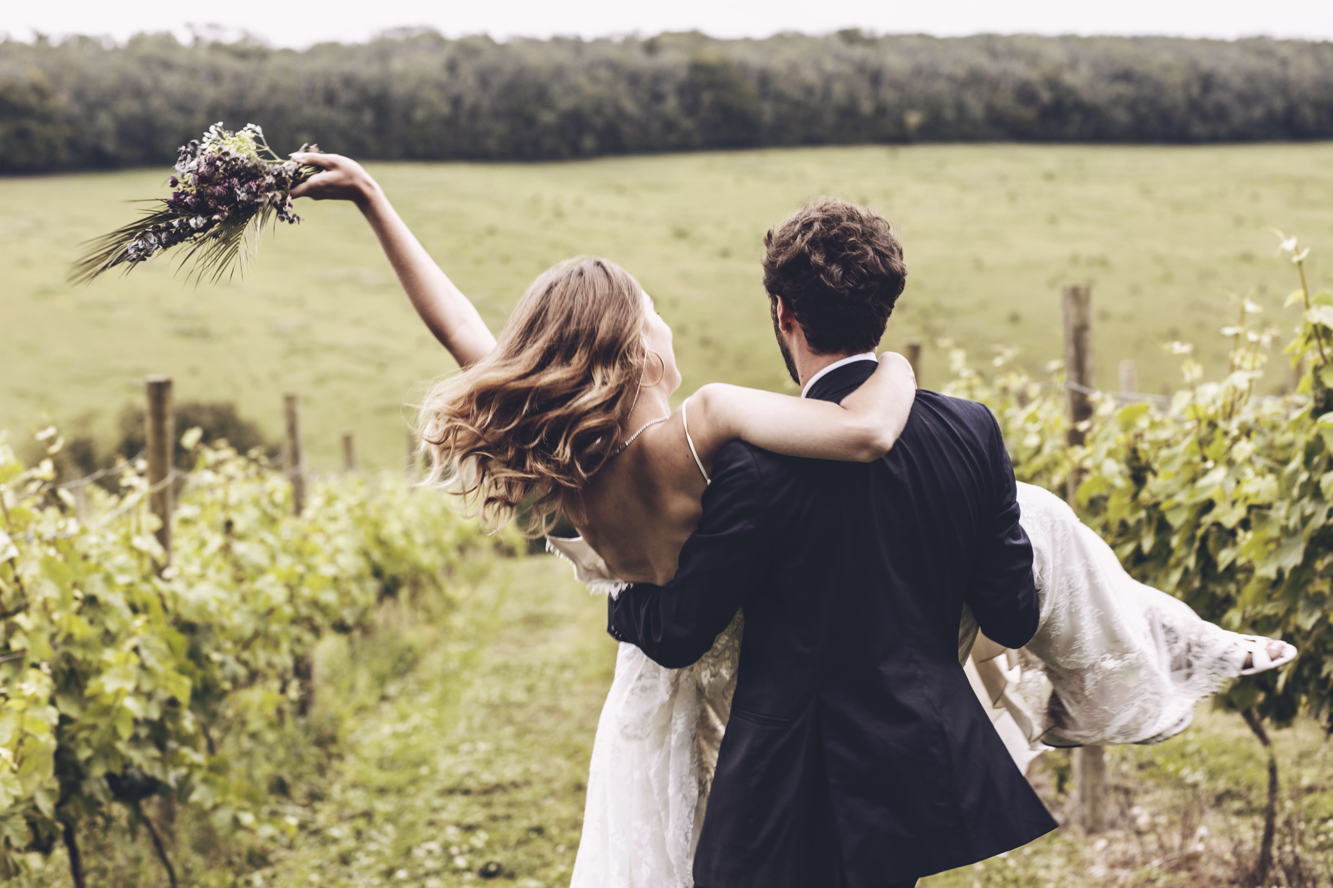 Groom Fireman Lifting Bride In the Countryside