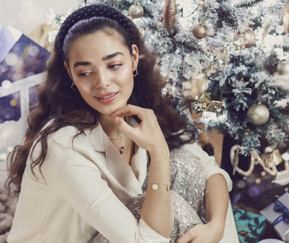 Woman In Front Of A Christmas Tree