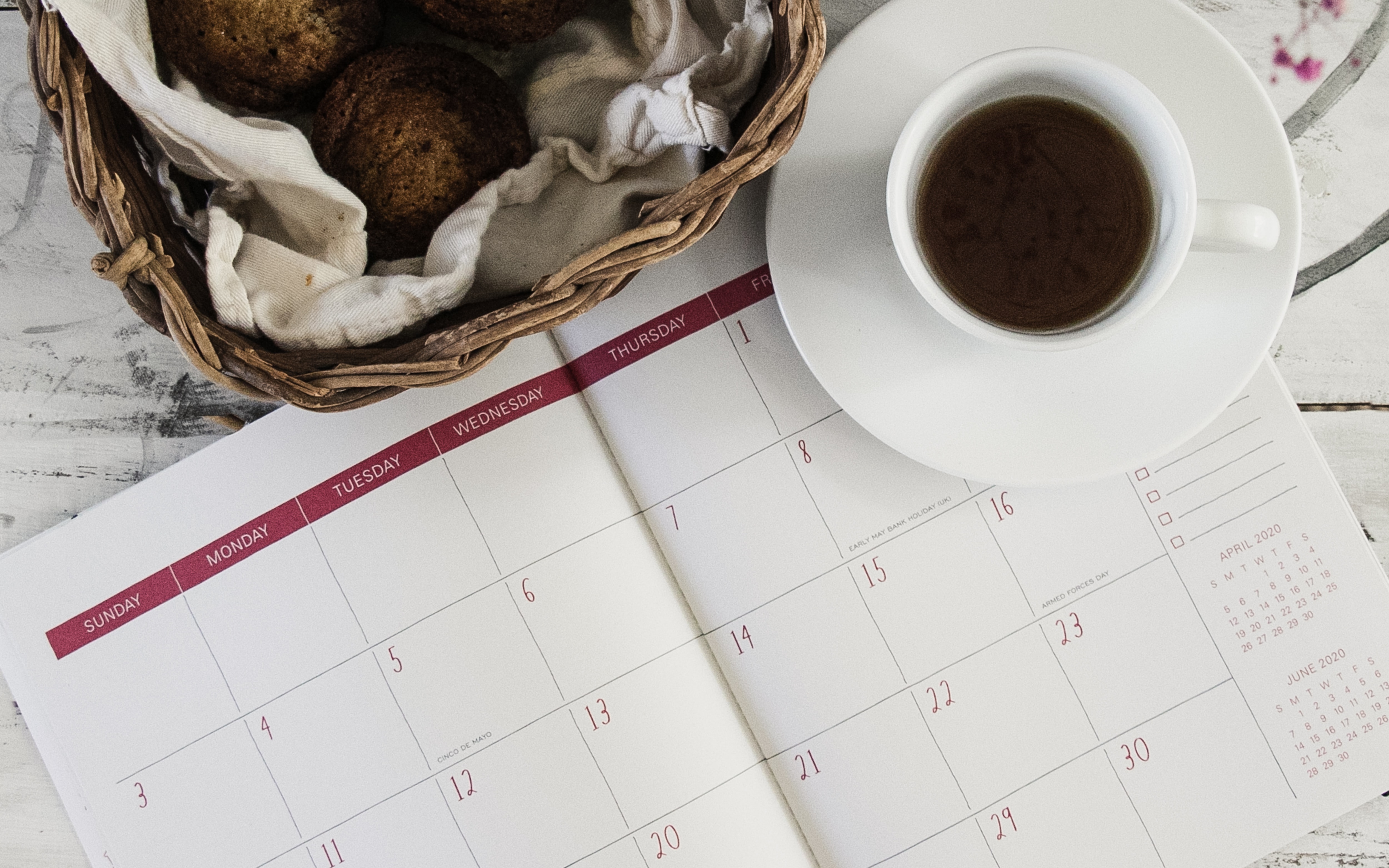 Weekly Planner Open with Coffee & Basket of Bread Rolls