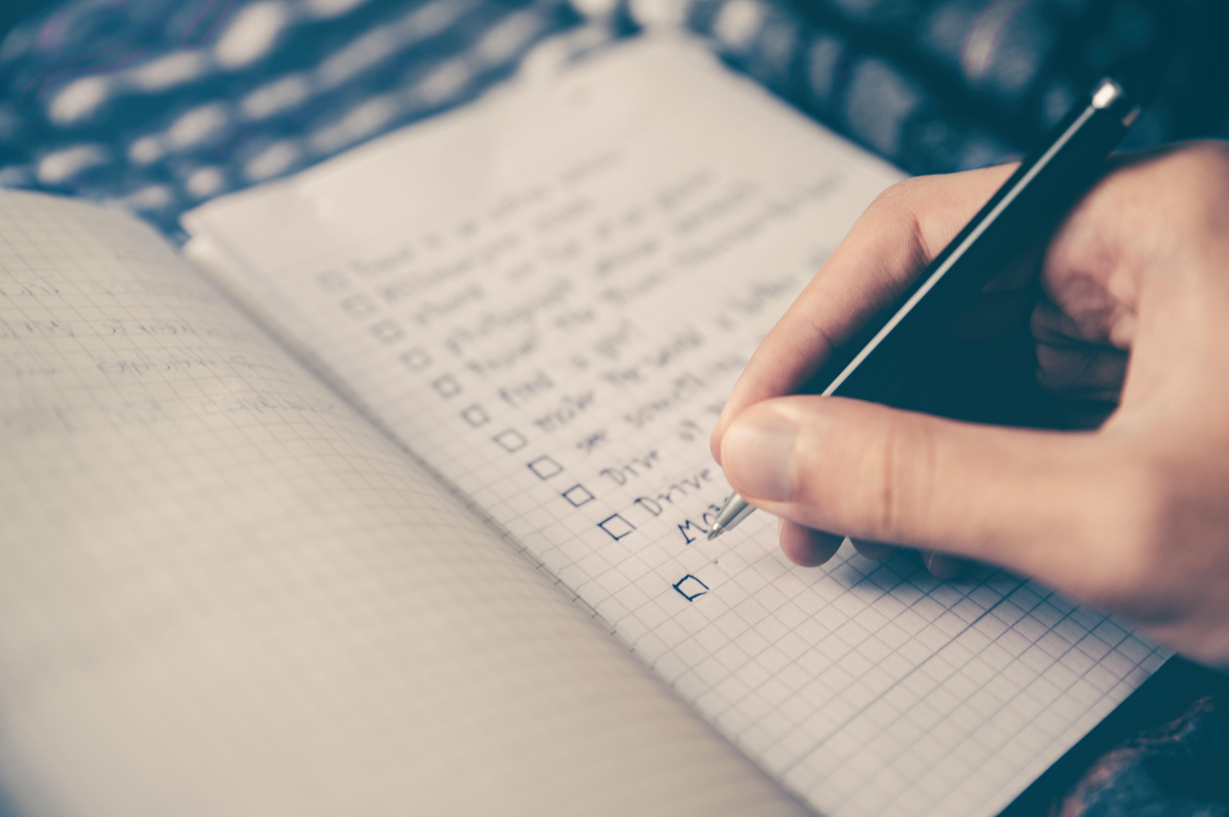 Person Listing Things to do on a Notebook