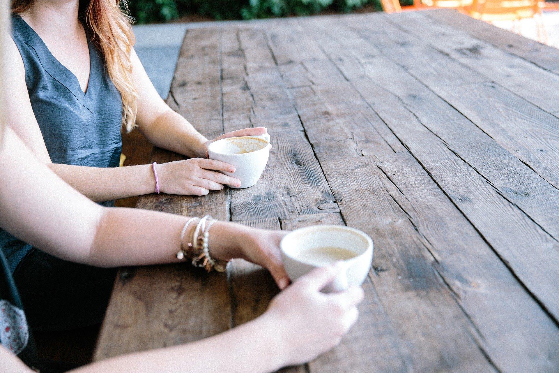 Two People Having Coffee & Chatting