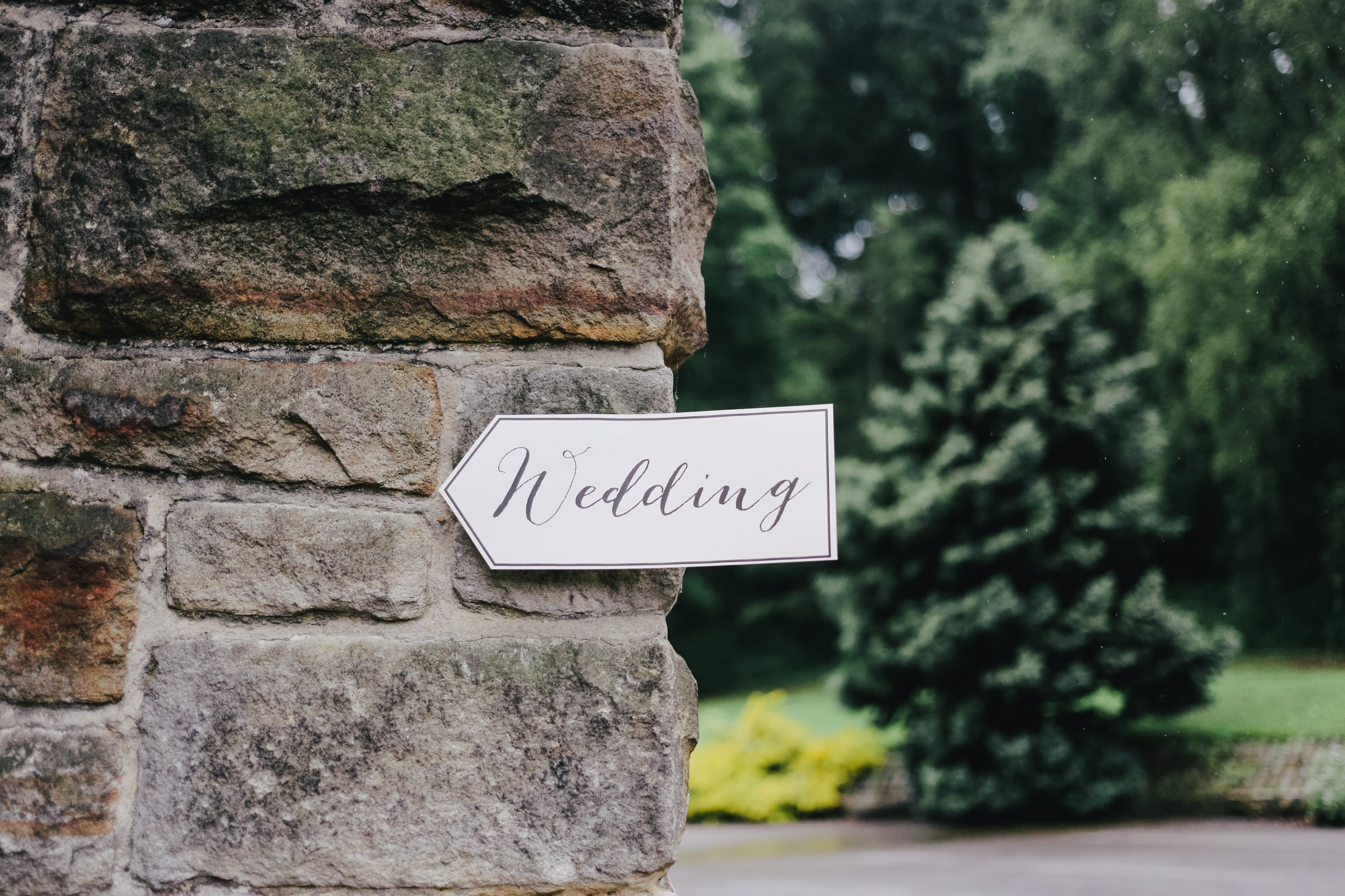 Arrow Sign with Wedding On it Stuck on a Wall